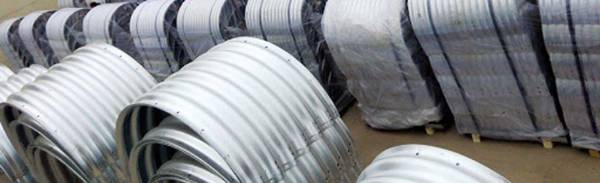 Various assembled corrugated metal pipes are displayed.